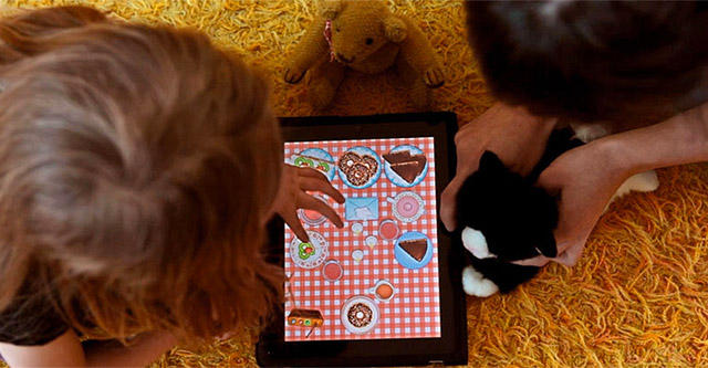 photo of child playing on a tablet